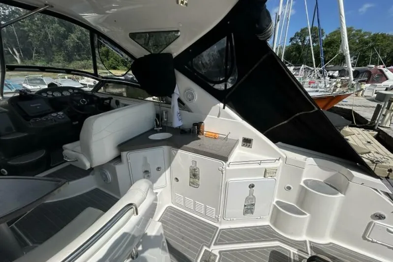  Yacht Photos Pics 2007 Regal 3760 Commodore boat interior with helm, seating, and storage compartments at a marina.