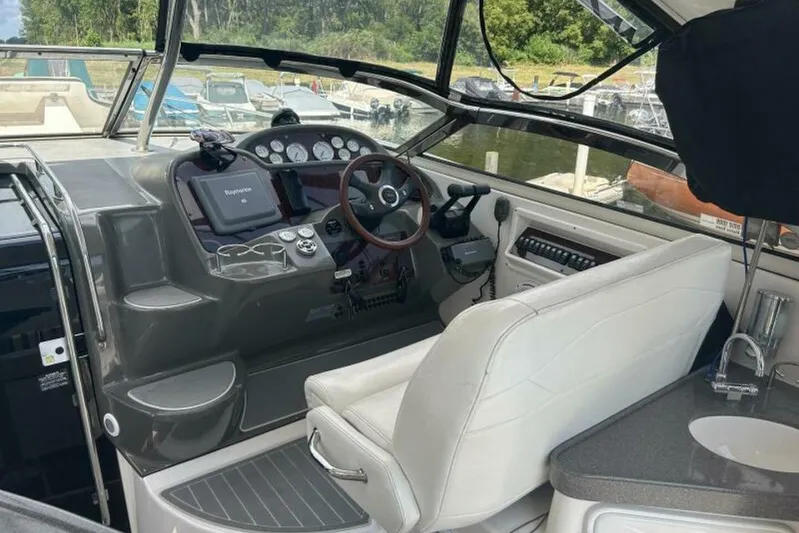  Yacht Photos Pics 2007 Regal 3760 Commodore boat cockpit with steering wheel and navigation equipment.