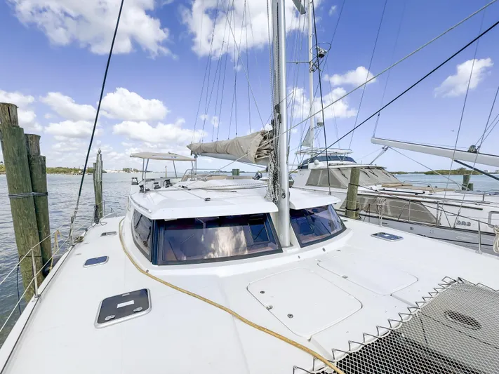 Alisei Yacht Photos Pics 2017 Fountaine Pajot Helia 44 Evolution catamaran docked under a clear blue sky.