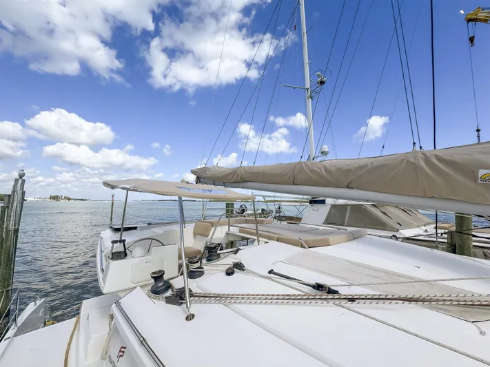 Alisei Yacht Photos Pics 2017 Fountaine Pajot Helia 44 Evolution catamaran docked under a clear blue sky.