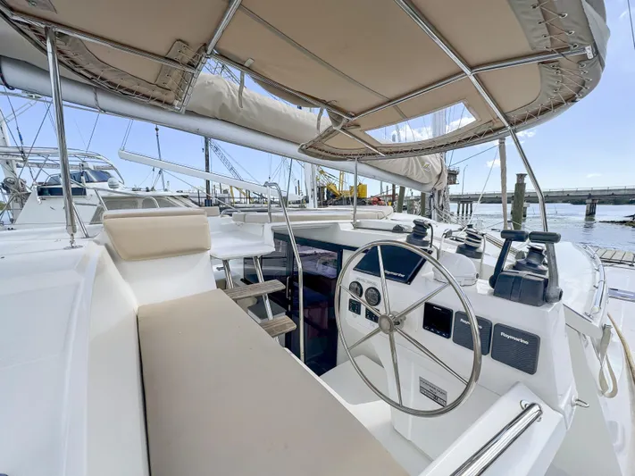 Alisei Yacht Photos Pics Helia 44 Evolution catamaran cockpit, 2017 model, featuring modern navigation equipment and comfortable seating.