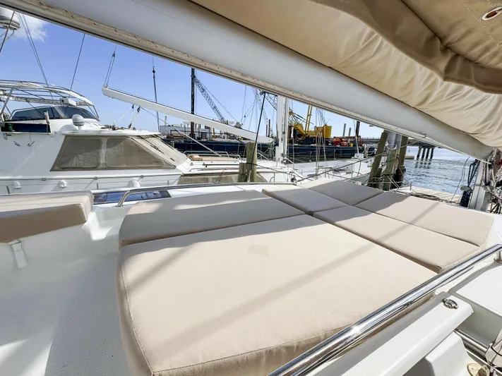 Alisei Yacht Photos Pics Luxurious sunbathing area on 2017 Fountaine Pajot Helia 44 Evolution catamaran docked at marina.