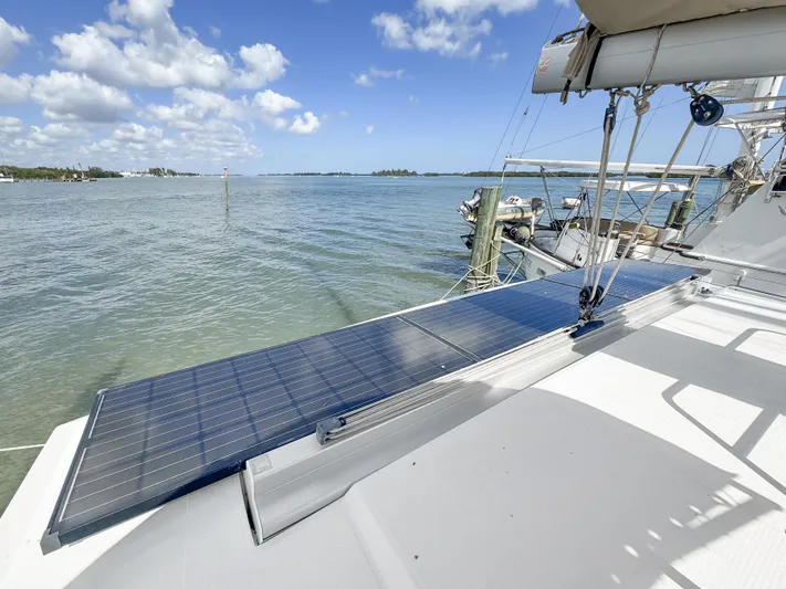 Alisei Yacht Photos Pics 2017 Fountaine Pajot Helia 44 Evolution with solar panels on deck, docked by the water.