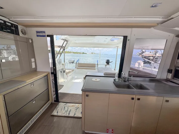 Alisei Yacht Photos Pics Interior view of 2017 Fountaine Pajot Helia 44 Evolution catamaran, featuring modern kitchen and ocean view.