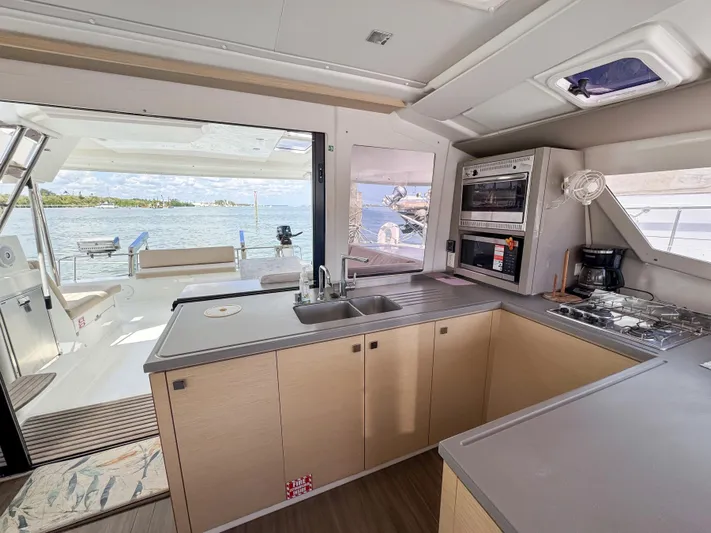 Alisei Yacht Photos Pics Modern kitchen interior of 2017 Fountaine Pajot Helia 44 Evolution yacht with ocean view.