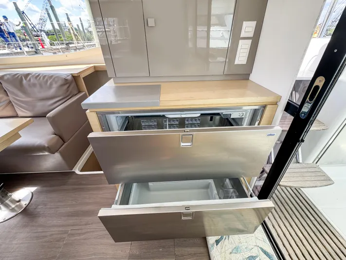 Alisei Yacht Photos Pics Modern kitchen area in 2017 Fountaine Pajot Helia 44 Evolution yacht with open drawers.