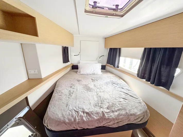 Alisei Yacht Photos Pics Cabin interior of 2017 Fountaine Pajot Helia 44 Evolution catamaran, featuring a cozy bed.
