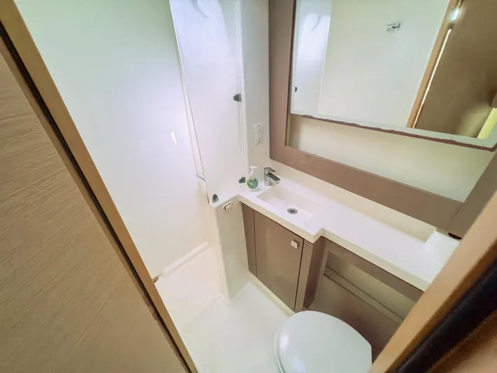 Alisei Yacht Photos Pics 2017 Fountaine Pajot Helia 44 Evolution yacht bathroom with modern fixtures and mirror.