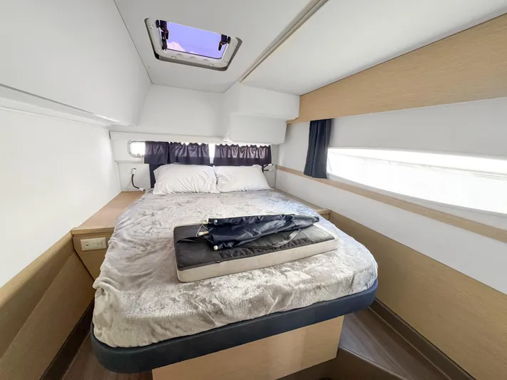 Alisei Yacht Photos Pics Cabin interior of 2017 Fountaine Pajot Helia 44 Evolution catamaran with cozy bed and skylight.