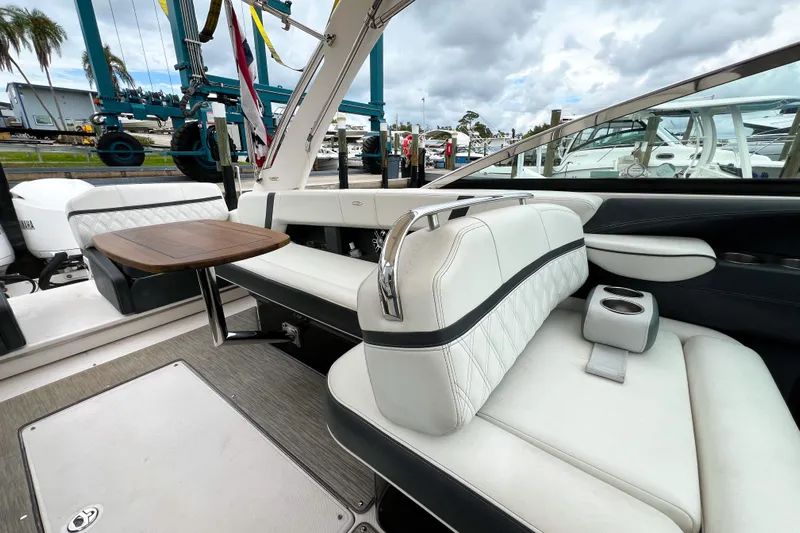  Yacht Photos Pics 2019 Regal 29 OBX boat interior with white seating and wooden table.