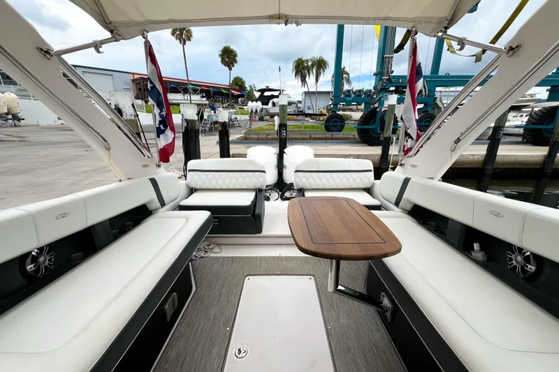  Yacht Photos Pics Luxurious 2019 Regal 29 OBX boat interior with elegant seating and wooden table.