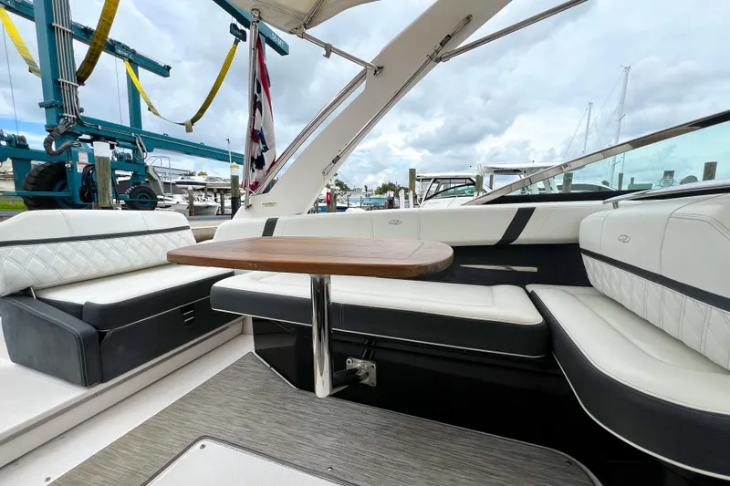  Yacht Photos Pics 2019 Regal 29 OBX boat interior with elegant seating and wooden table.