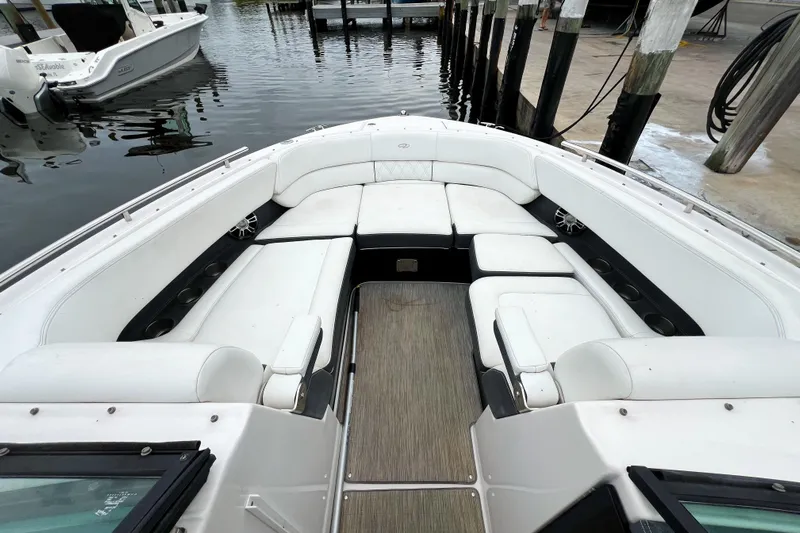 Yacht Photos Pics 2019 Regal 29 OBX boat with spacious white seating and sleek design at dock.