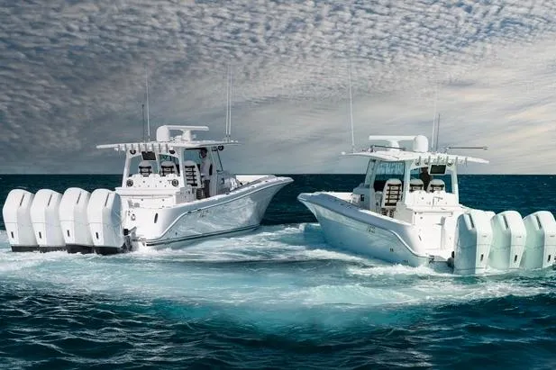  Yacht Photos Pics 2026 HCB 42 Lujo boats cruising on open water under a cloudy sky.