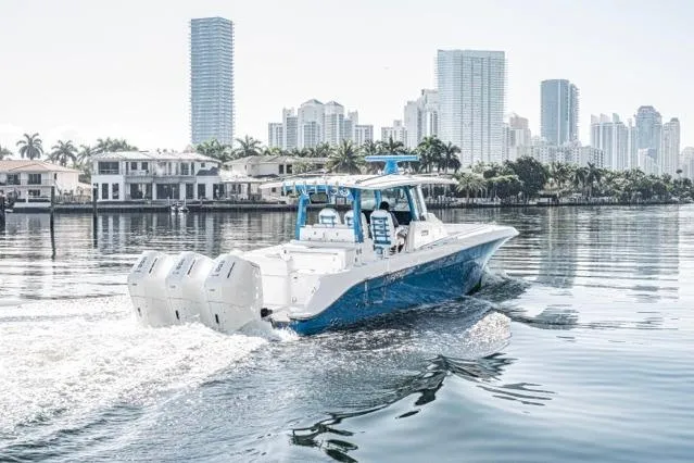  Yacht Photos Pics 2026 HCB 42 Lujo boat cruising near city skyline and waterfront homes.