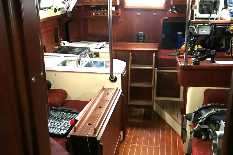  Yacht Photos Pics Interior of a 1990 Pacific Seacraft 37 sailboat with wooden finishes and nautical equipment.