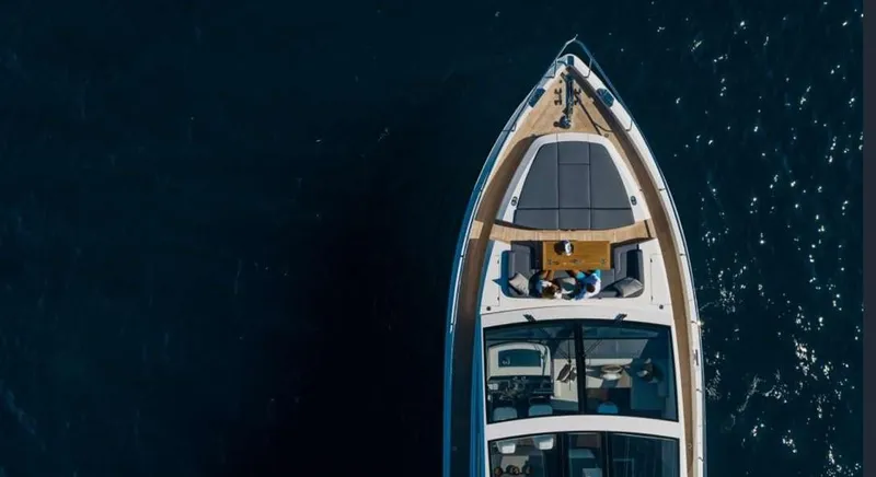  Yacht Photos Pics Aerial view of 2020 Pearl 80 yacht cruising on dark blue water.