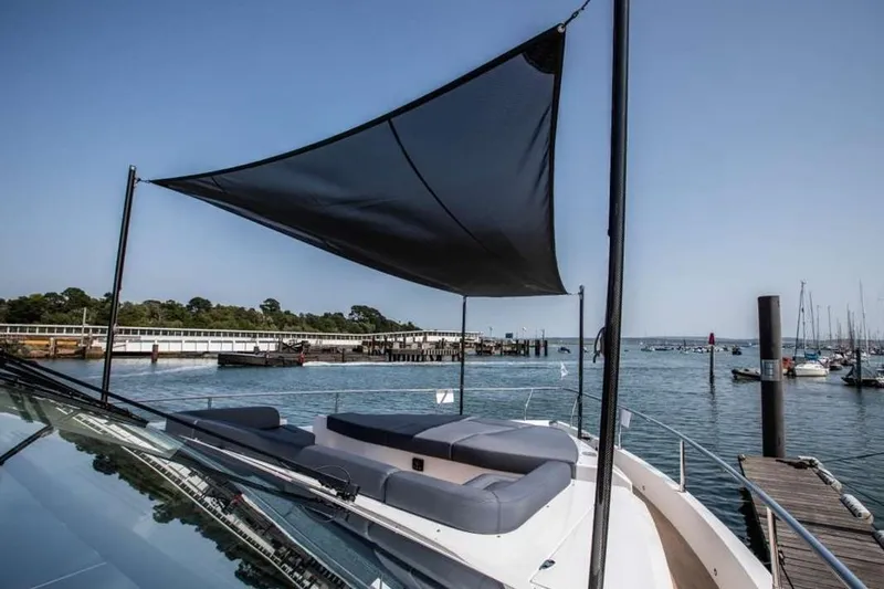  Yacht Photos Pics Luxurious Pearl 80 yacht with sunshade, docked at a scenic marina, 2020 model.