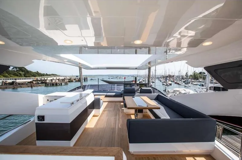  Yacht Photos Pics Luxurious Pearl 80 yacht interior, 2020 model, featuring elegant seating and scenic marina views.