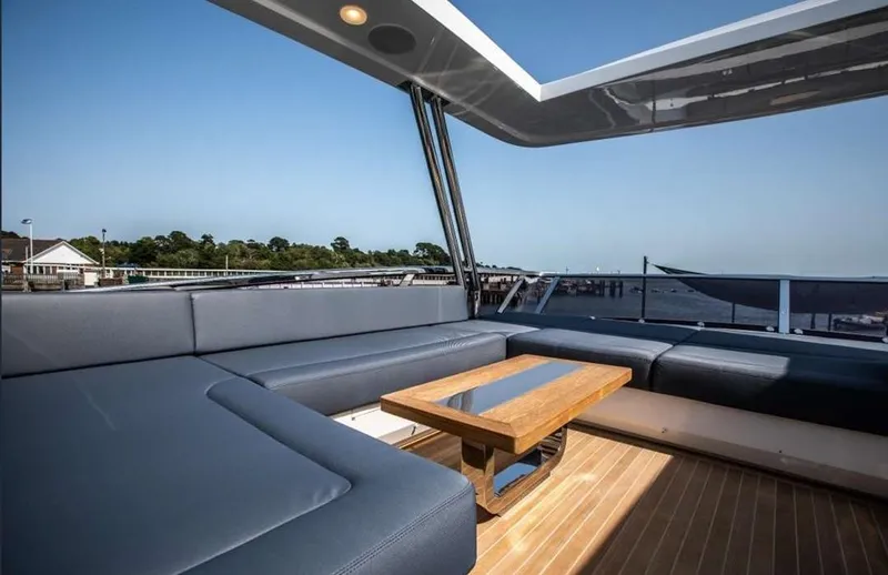  Yacht Photos Pics Luxurious Pearl 80 yacht deck with modern seating and wooden table, 2020 model.