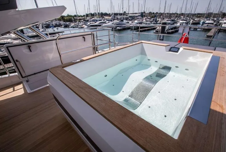  Yacht Photos Pics Luxurious hot tub on Pearl 80 yacht, 2020 model, docked at marina with sailboats.