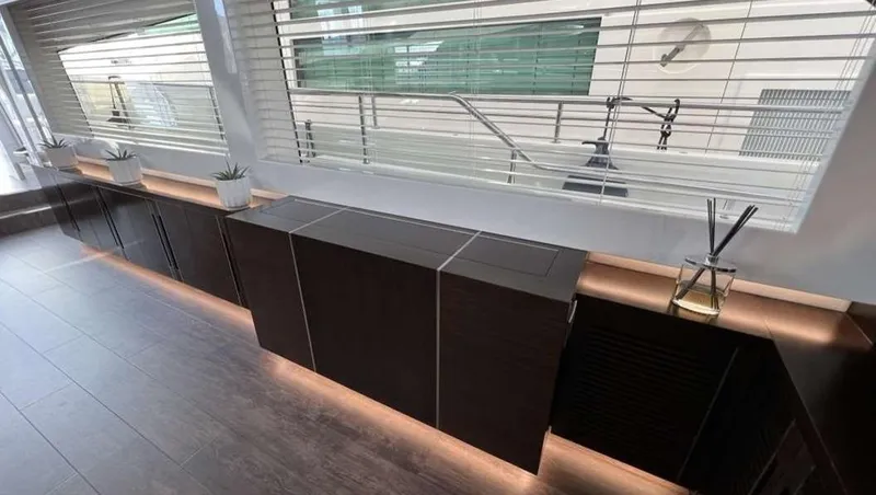  Yacht Photos Pics Modern interior with sleek cabinets, ambient lighting, and decorative plants on a Pearl 80 yacht.