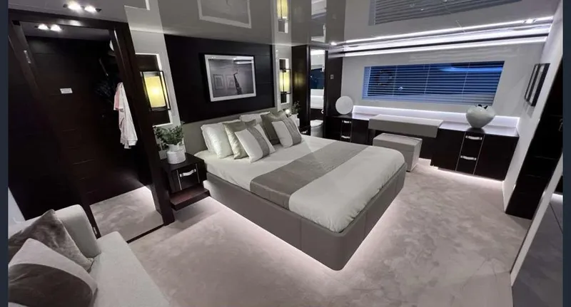  Yacht Photos Pics Luxurious bedroom interior in a 2020 Pearl 80 yacht, featuring modern design and ambient lighting.