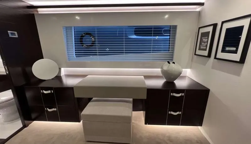  Yacht Photos Pics Modern yacht interior with sleek cabinetry, round mirror, and decorative vase, Pearl 80, 2020 model.