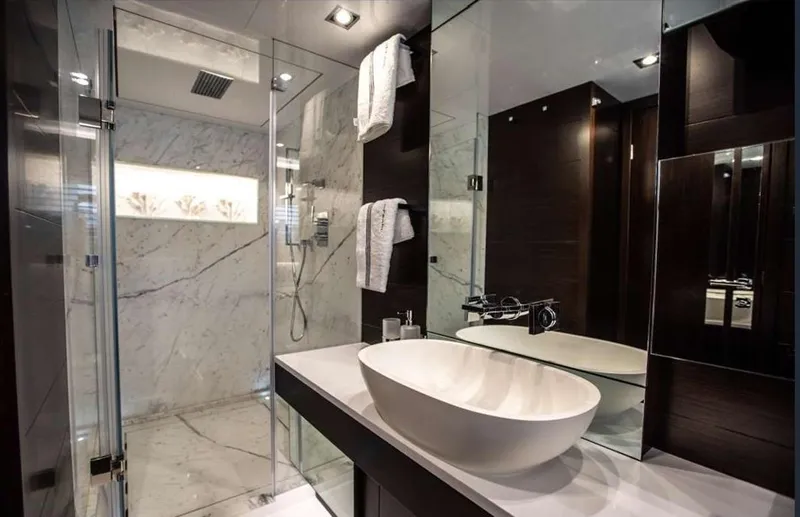  Yacht Photos Pics Modern bathroom with marble shower, vessel sink, and dark wood accents, Pearl 80, 2020 model.