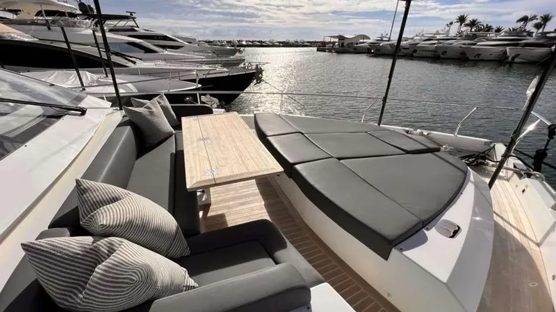  Yacht Photos Pics Luxurious Pearl 80 yacht deck with seating and table, docked at marina, 2020 model.
