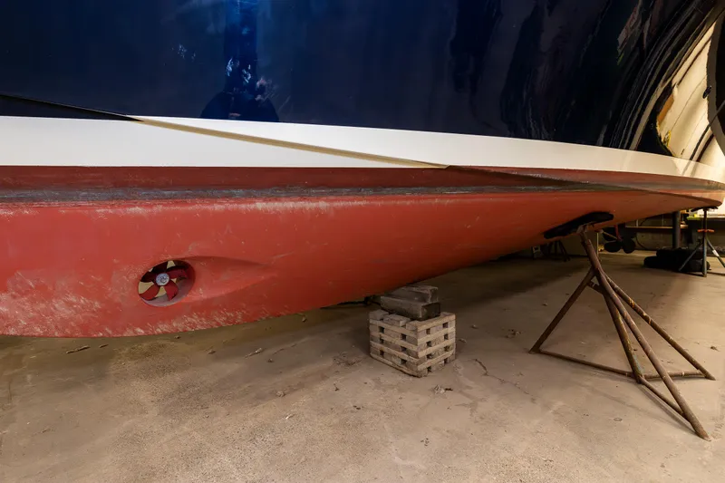 Rough Rider Yacht Photos Pics 2006 Palm Beach Motor Yachts Avalon 32 hull in dry dock, showcasing propeller and support stands.