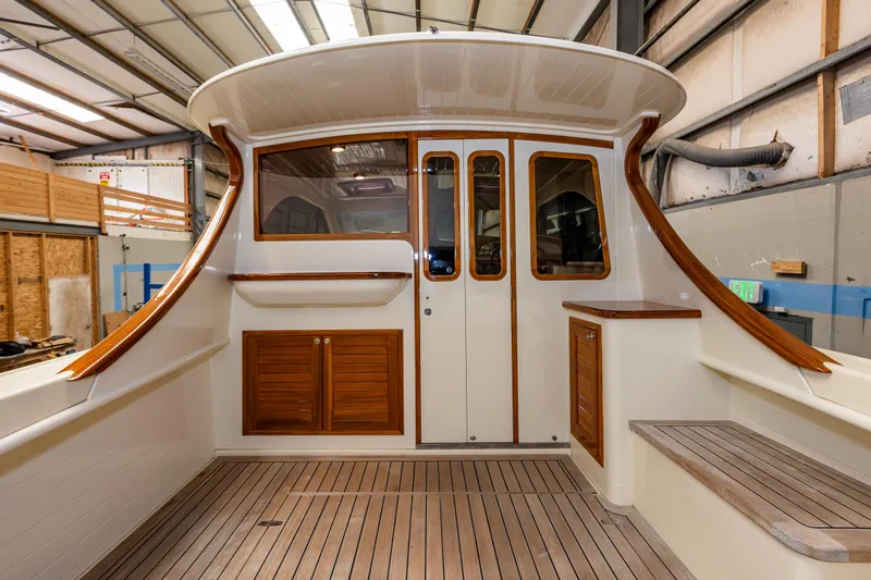 Rough Rider Yacht Photos Pics 2006 Palm Beach Motor Yachts Avalon 32 interior with wood accents and spacious deck.