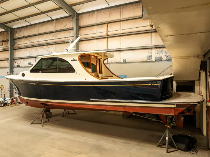 Rough Rider Yacht Photos Pics 2006 Palm Beach Motor Yachts Avalon 32 in a warehouse, elevated on supports.