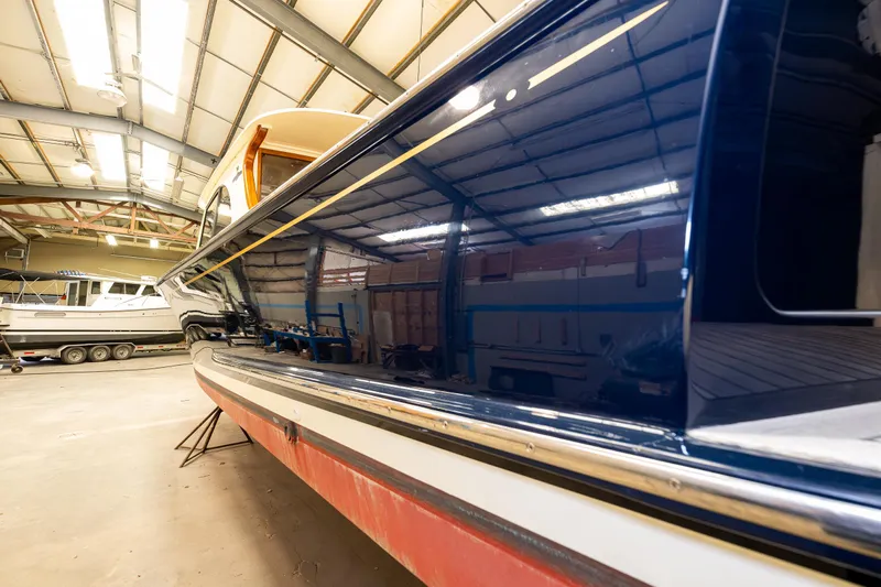 Rough Rider Yacht Photos Pics 2006 Palm Beach Motor Yachts Avalon 32 in a boatyard, showcasing sleek design and craftsmanship.