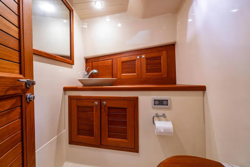 Rough Rider Yacht Photos Pics Luxurious wooden bathroom interior of 2006 Palm Beach Avalon 32 yacht.