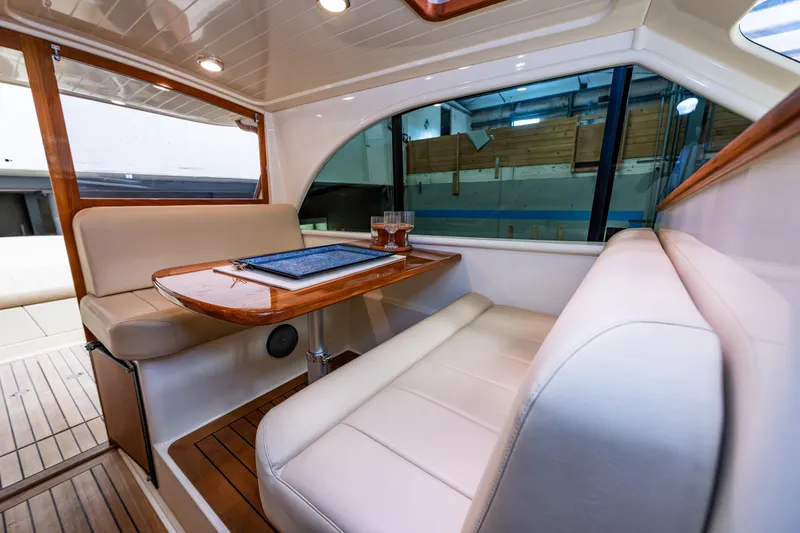 Rough Rider Yacht Photos Pics Luxurious interior of 2006 Palm Beach Motor Yachts Avalon 32 with elegant seating and table.