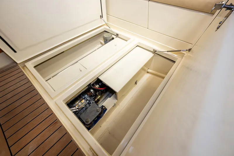 Rough Rider Yacht Photos Pics Engine compartment of 2006 Palm Beach Motor Yachts Avalon 32, showcasing storage and mechanical components.