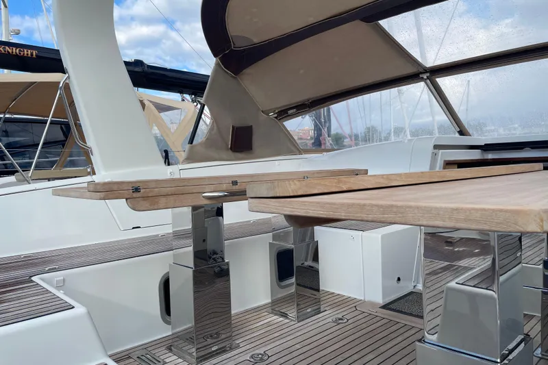  Yacht Photos Pics Luxurious Jeanneau Yachts 64 cockpit with wooden table, sleek design, and modern amenities, 2015 model.