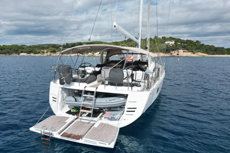  Yacht Photos Pics 2015 Jeanneau Yachts 64 anchored in serene coastal waters, showcasing elegant design and spacious deck.