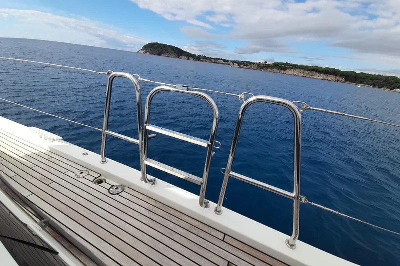  Yacht Photos Pics Jeanneau Yachts 64 (2015) deck view with ocean and distant coastline.