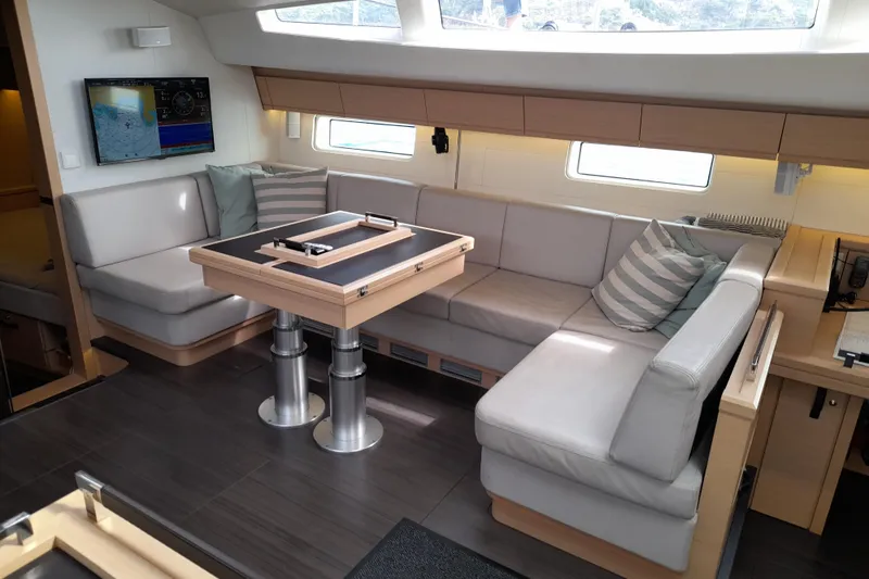  Yacht Photos Pics Luxurious interior of 2015 Jeanneau Yachts 64 with modern seating and navigation display.