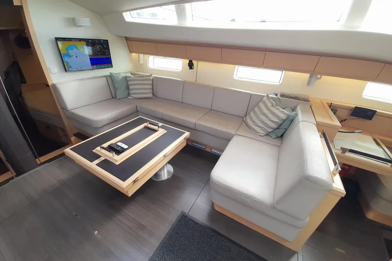 Yacht Photos Pics Luxurious interior of 2015 Jeanneau Yachts 64 with modern seating and navigation display.