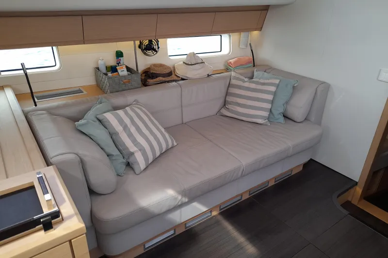  Yacht Photos Pics Luxurious interior of 2015 Jeanneau Yachts 64 with comfortable seating and stylish decor.