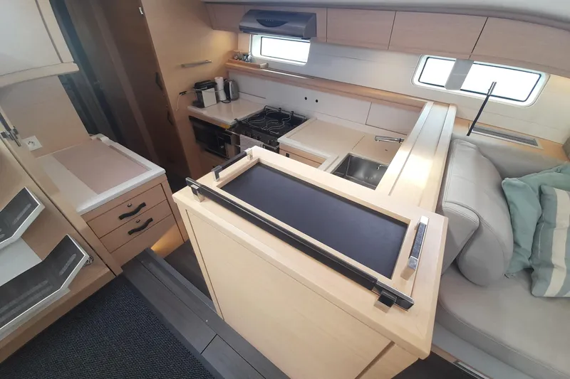  Yacht Photos Pics Interior of 2015 Jeanneau Yachts 64, featuring modern kitchen and seating area.