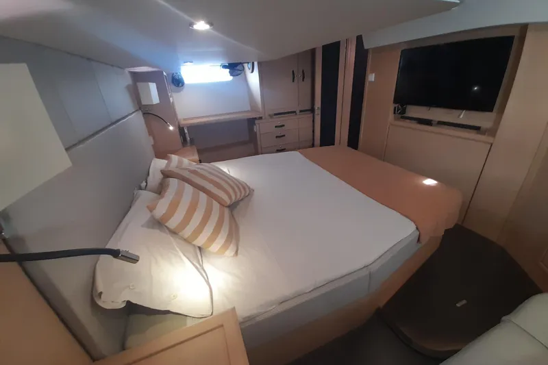  Yacht Photos Pics Luxurious cabin interior of 2015 Jeanneau Yachts 64 with cozy bed and modern amenities.