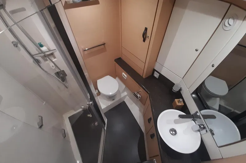  Yacht Photos Pics Luxurious bathroom in 2015 Jeanneau Yachts 64, featuring modern fixtures and elegant design.