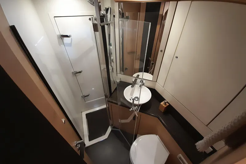  Yacht Photos Pics Luxurious bathroom in 2015 Jeanneau Yachts 64, featuring modern shower and sleek vanity.