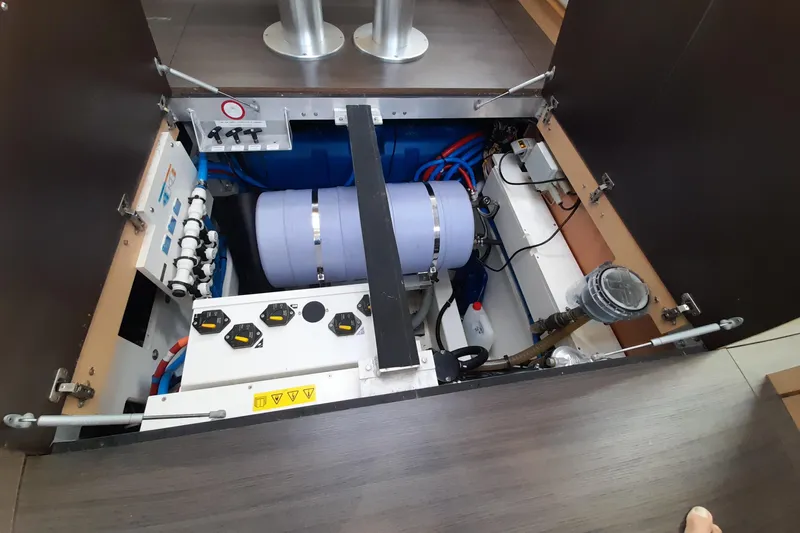  Yacht Photos Pics Engine compartment of a 2015 Jeanneau Yachts 64, showcasing mechanical components and wiring.