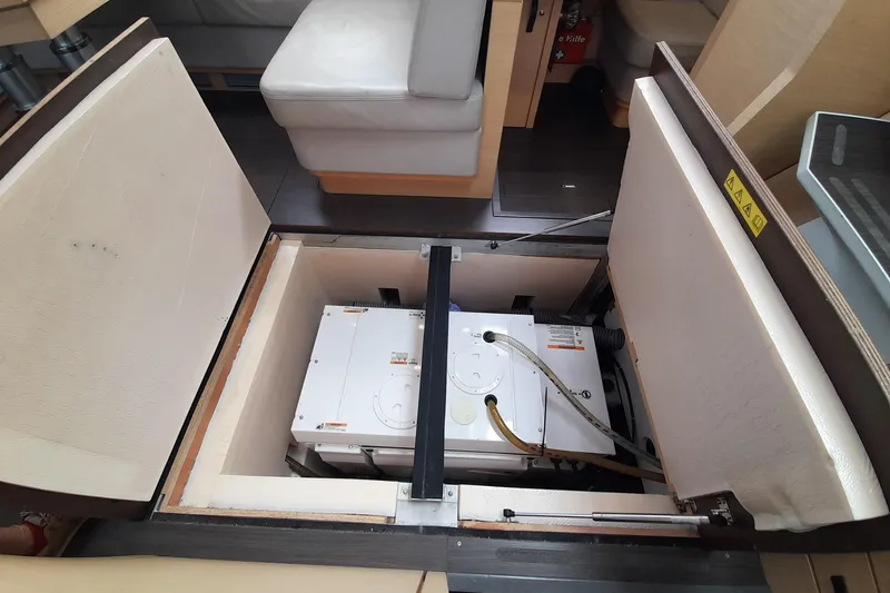  Yacht Photos Pics Interior view of 2015 Jeanneau Yachts 64, showcasing under-seat storage compartment.