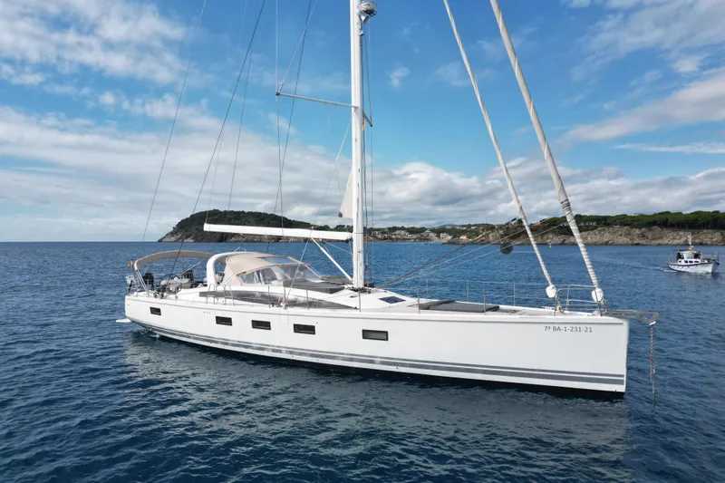  Yacht Photos Pics 2015 Jeanneau Yachts 64 sailing on calm blue waters under a clear sky.